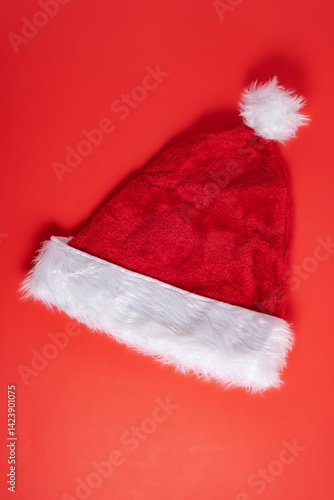Red velour Santa hat on red background
