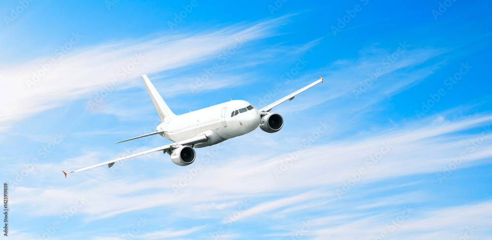 Obraz premium Airplane in the sky, travel background with flying airplane with blank livery, air travel background