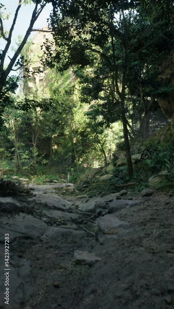 An unpaved road winds through a rocky forest, surrounded by towering trees, creating a picturesque scene devoid of any human or animal presence. An unpaved road winds through a rocky forest, surrounded by towering trees, creating a picturesque scene devoid of any human or animal presence.