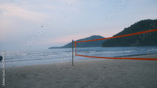 Wallpaper Mural Photo of an empty beach with a volleyball net / beach tennis net, soft pink sky, and ocean waves in the background. Captured right before sunset in Ubatuba, coast of São Paulo. Torontodigital.ca