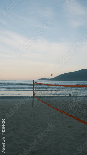 Wallpaper Mural Photo of an empty beach with a volleyball net / beach tennis net, soft pink sky, and ocean waves in the background. Captured right before sunset in Ubatuba, coast of São Paulo. Torontodigital.ca