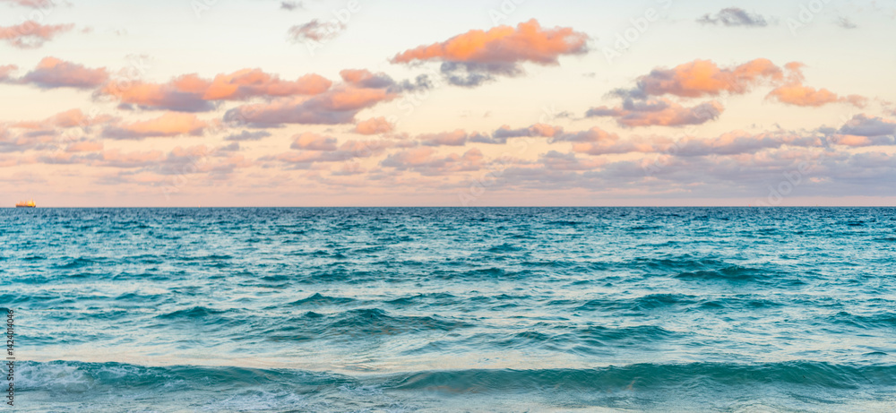 Obraz premium Skyscape with sea horizon. Calm horizon view at sea sunrise. Romantic summer vacation sunrise on seascape. Sea horizon view. Cloudy sky and seascape at summer vacation. Sea waves