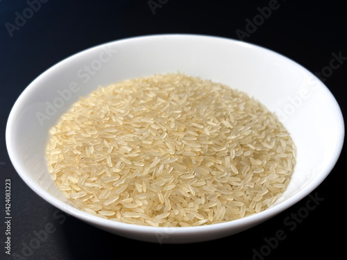 Cooked rice on dark background.