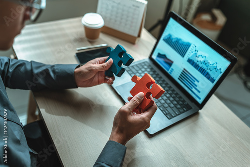 Photography Businessman is hands hold puzzle and join together in a jigsaw puzzle