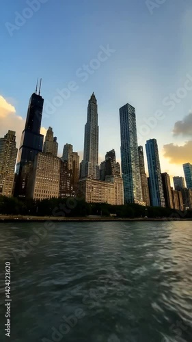 New York City's urban skyline at sunset showcases Manhattan skyscrapers reflecting in the river
