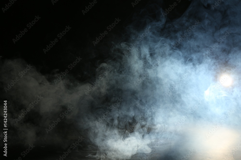 Fototapeta premium Beautiful smoke in lights on dark background