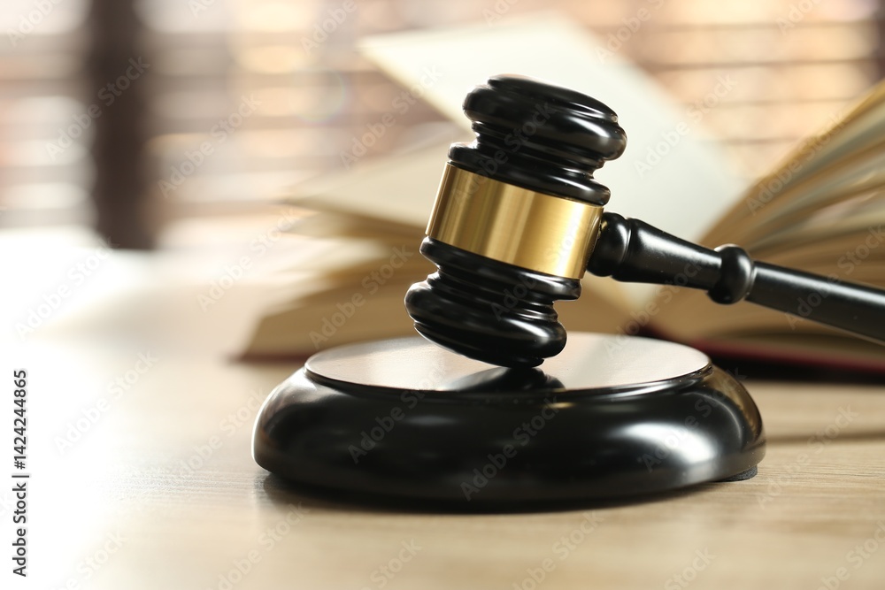 Judge's gavel and book on wooden table indoors, selective focus Judge's gavel and book on wooden table indoors, selective focus