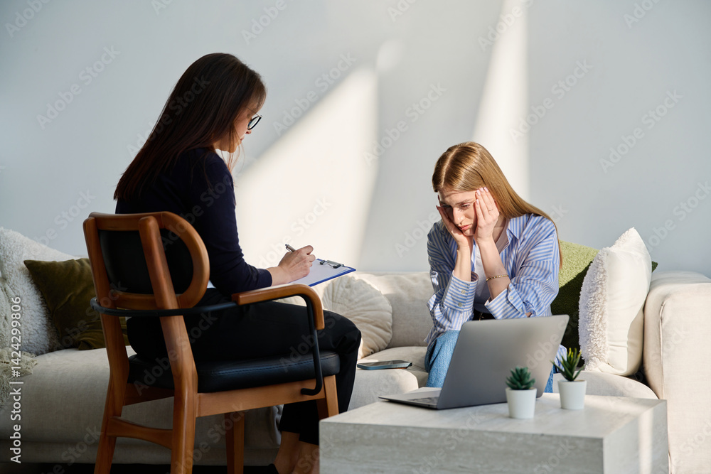 Sad upset young female patient in therapy session in psychologist office