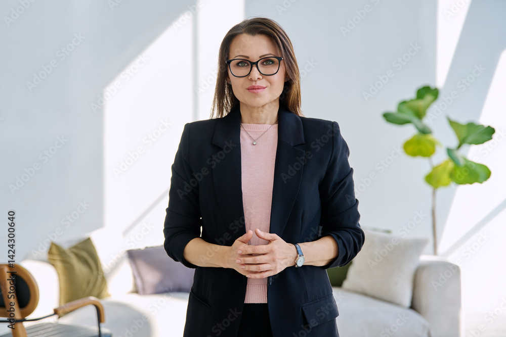 Portrait confident middle aged businesswoman posing with folded hands