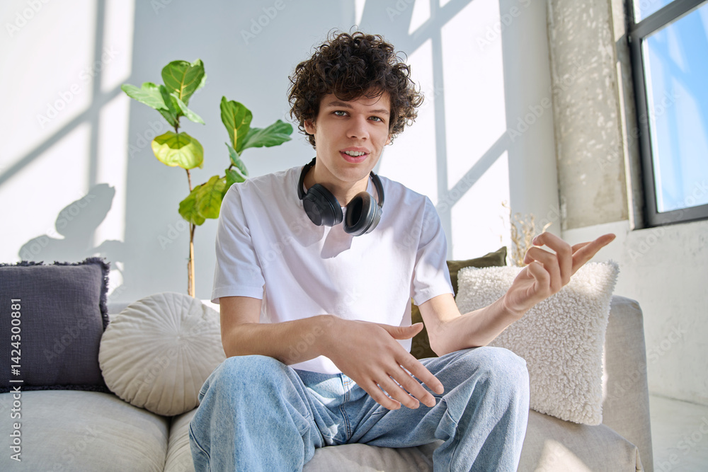 Young guy university student talking looking in web camera, at home