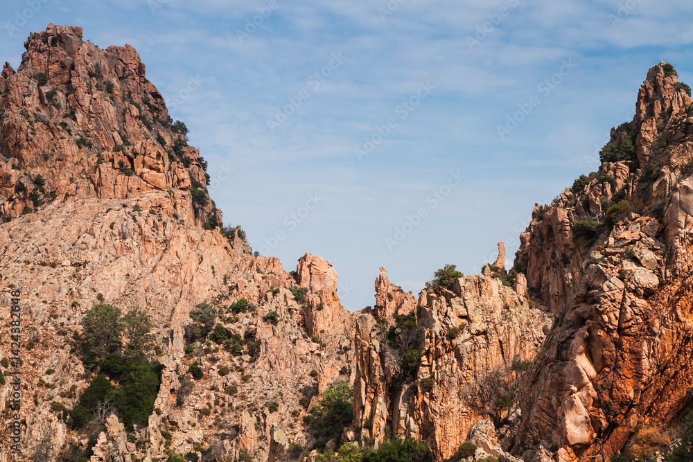 Fototapeta premium A picturesque view of rocky mountain formations under blue sky. Corsica