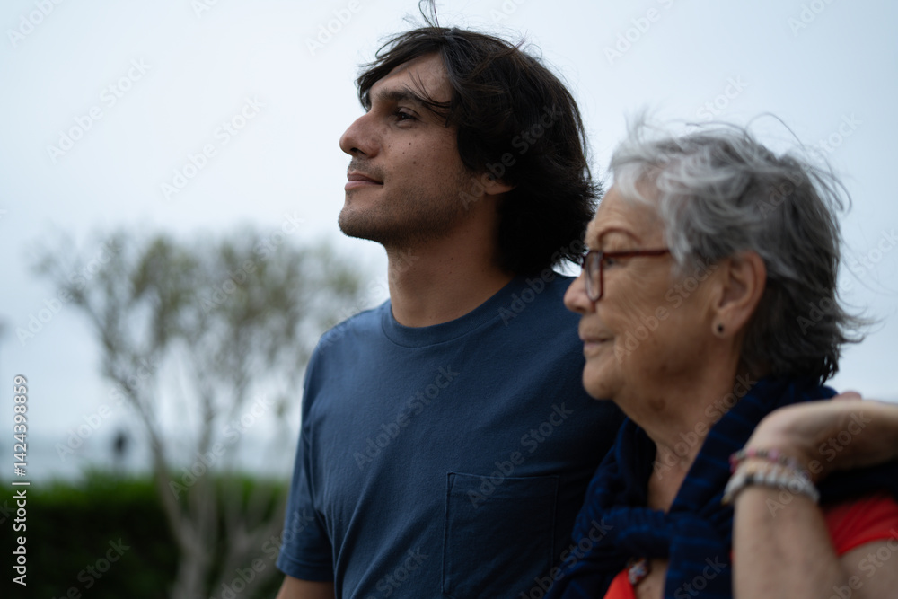 Grandson showing respect and love for grandmother on boardwalk Grandson showing respect and love for grandmother on boardwalk