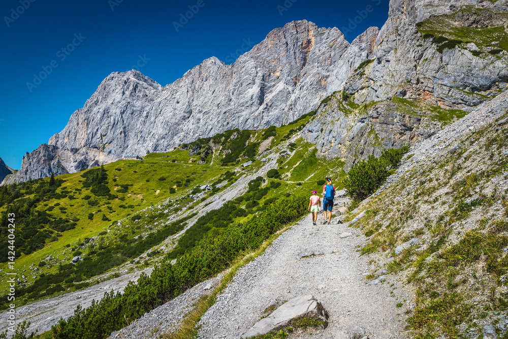 Hikers on the gravelly hiking trail, Dachstein mountains, Austria