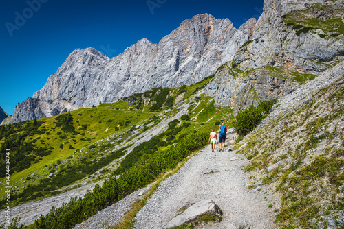 Obraz na płótnie Hikers on the gravelly hiking trail, Dachstein mountains, Austria w salonie