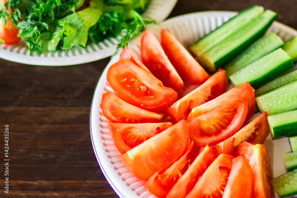 Close-up of fresh cucumber and tomato salad on a white plate placed on a natural wooden table, with focus on vibrant colors and texture of the vegetables.
Close-up of fresh cucumber and tomato salad on a white plate placed on a natural wooden table, with focus on vibrant colors and texture of the vegetables.