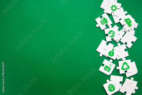Scattered Sustainability Puzzle Pieces with Green Icons. puzzle pieces featuring various green environmental symbols arranged vertically on right side of rich green background with copy space.