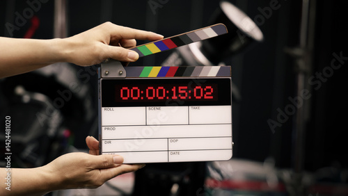 Digital film slate for filmmaker in set. Hand hitting timecode clapperboard or movie slate for Video Production. Digi number clapper board or film slates action on set. Tools in modern cinema industry