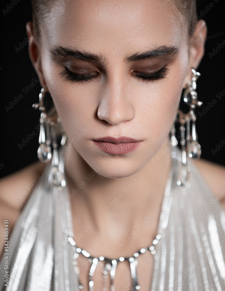 Beauty portrait of beautiful model in silver top and silver jewelry