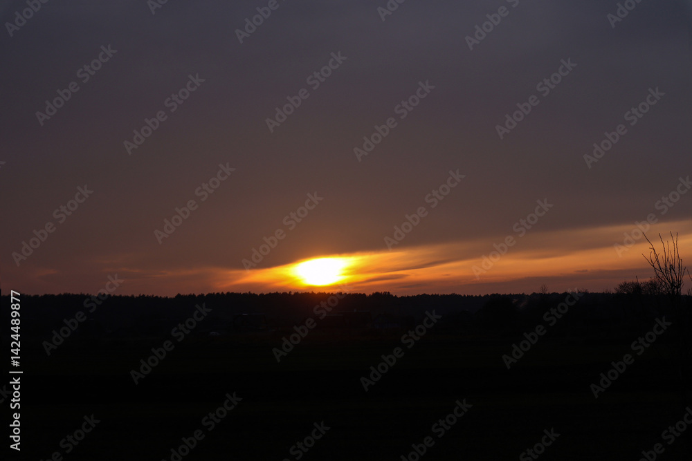 Blurry bright ball of sun in the evening sky during sunset Blurry bright ball of sun in the evening sky during sunset