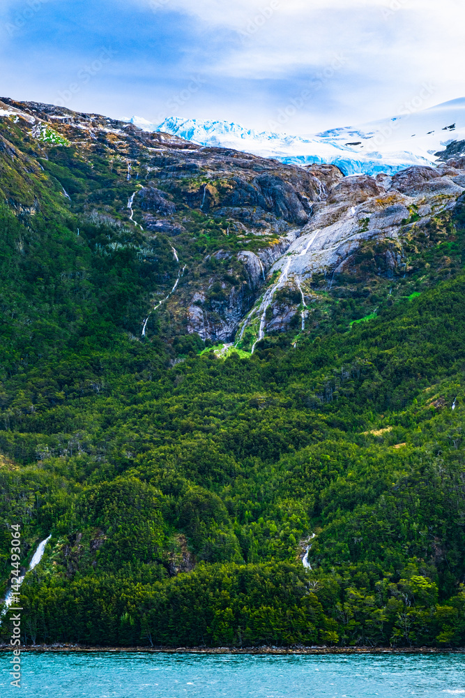 Fototapeta premium As glacial ice melts, the water flows downslope in the spring and summer forming beautiful waterfalls