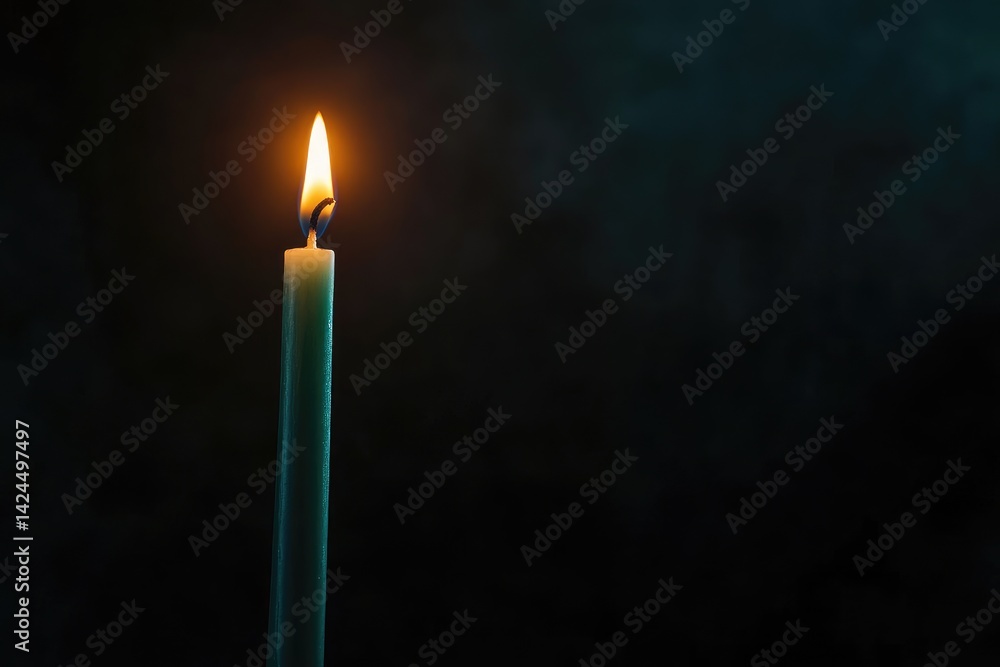 Fototapeta premium Solitary Candle Burning in the Dark - Symbol of Hope, Reflection, and Tranquility