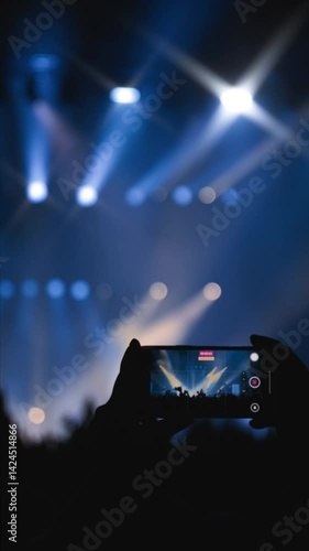 Wallpaper Mural Concerthall show. Medium close-up shot. Slow motion. Vertical shot. Woman hands with phone in foreground with a clapping crowd of fans Torontodigital.ca
