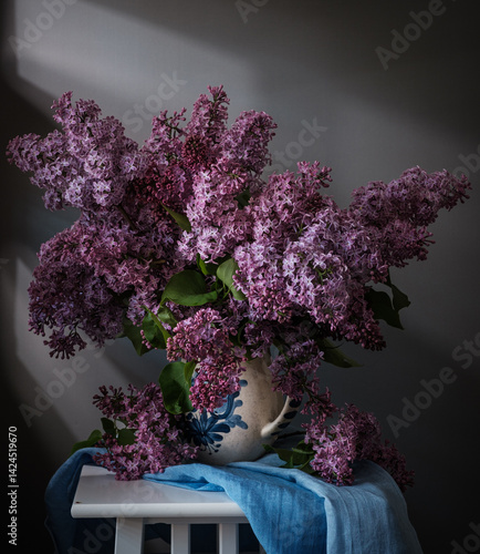 Obraz na płótnie A Beautiful and Vibrant Lilac Bouquet arranged in a Wicker Basket. w salonie