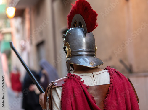 Photos Roman centurion wearing helmet with red plume holding spear during a historical