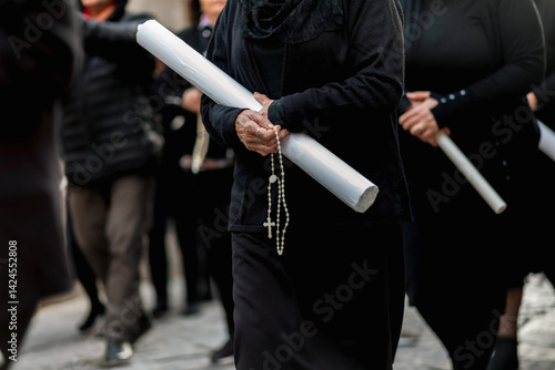 Photos Women holding candles and praying during Good Friday procession