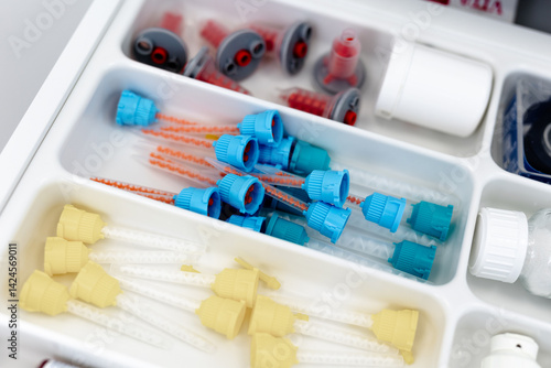 Close-up of sterilised dentist's instruments for working on teeth arranged on medical cabinet. Dental health concept