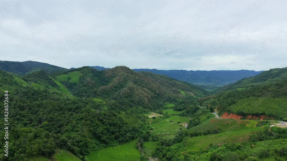 The rural expanses of Laos in Asia, Laos, between Vientiane and Luang Prabang, in summer, on a cloudy day. The rural expanses of Laos in Asia, Laos, between Vientiane and Luang Prabang, in summer, on a cloudy day.