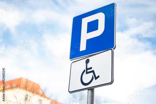 blue road sign on the parking lot for a disabled person prohibiting parking of a car