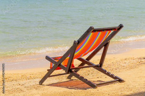 sun beach chairs on shore near sea.
