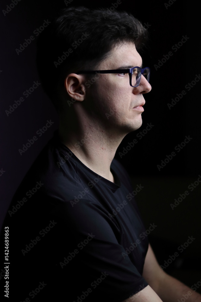 Fototapeta premium Portrait of a Man in Low Light Environment for Emotional Concept