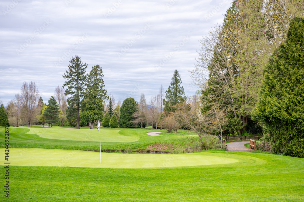 Obraz premium Golf course with gorgeous green and fantastic forest view in Vancouver, Canada, North America. Day time on April 2025.