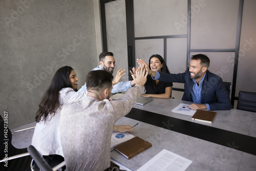 Ταπετσαρία Happy diverse team of professionals sit around conference table give high-five, gesture of teamwork, shared sense of accomplishment, celebrate achieving goal, completing milestone
