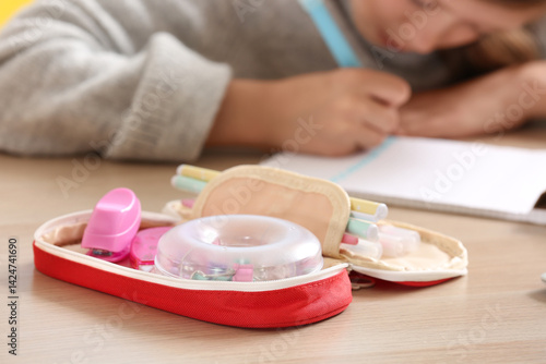 Open pencil case with schoo...
