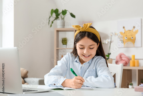 Little girl doing lessons a...