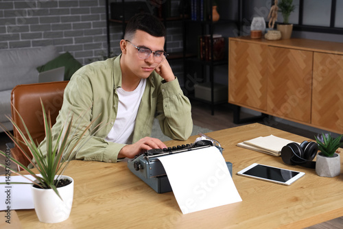 Tired young author typing o...