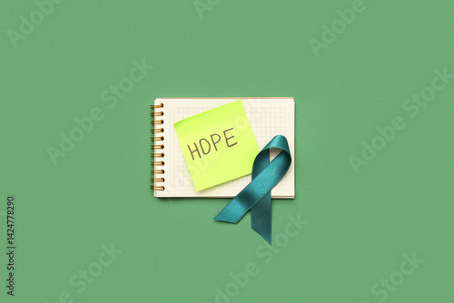 Teal ribbon and notebook wi...