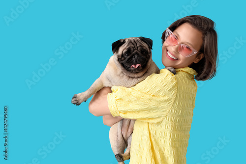 Young woman with cute pug d...