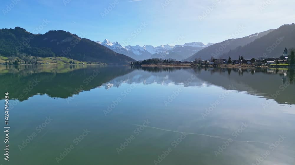 Sihlsee, Lake Sihl, of Switzerland in early spring with snowy Alps in the background Sihlsee, Lake Sihl, of Switzerland in early spring with snowy Alps in the background