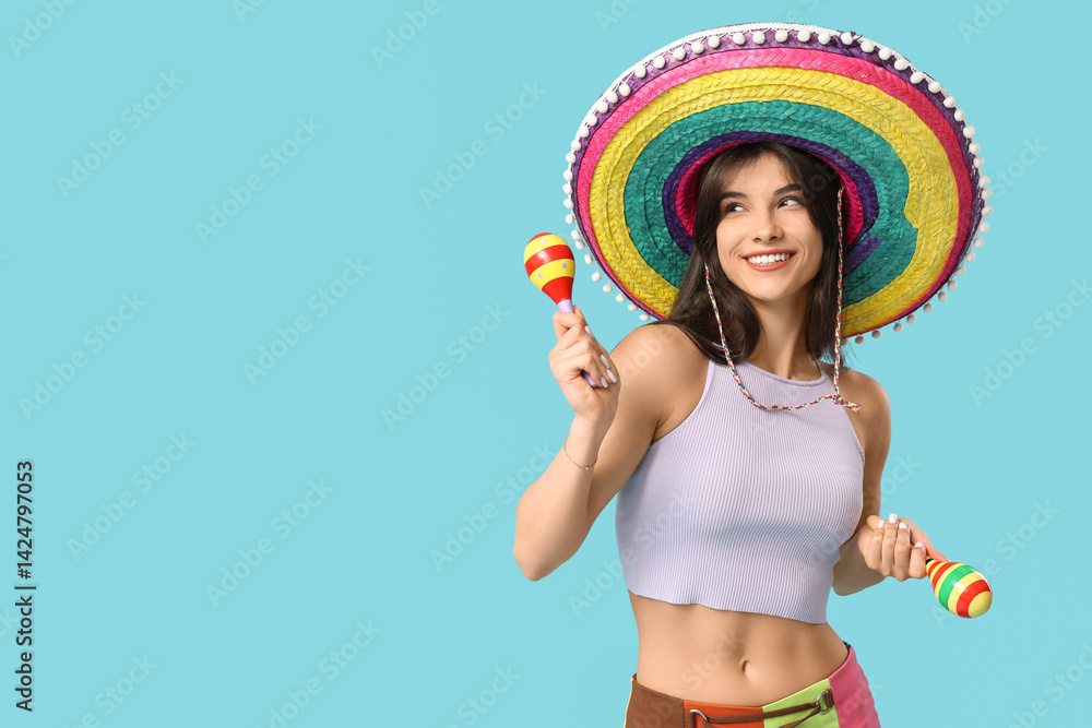 Young woman with colorful sombrero and maracas on blue background. Cinco de Mayo celebration