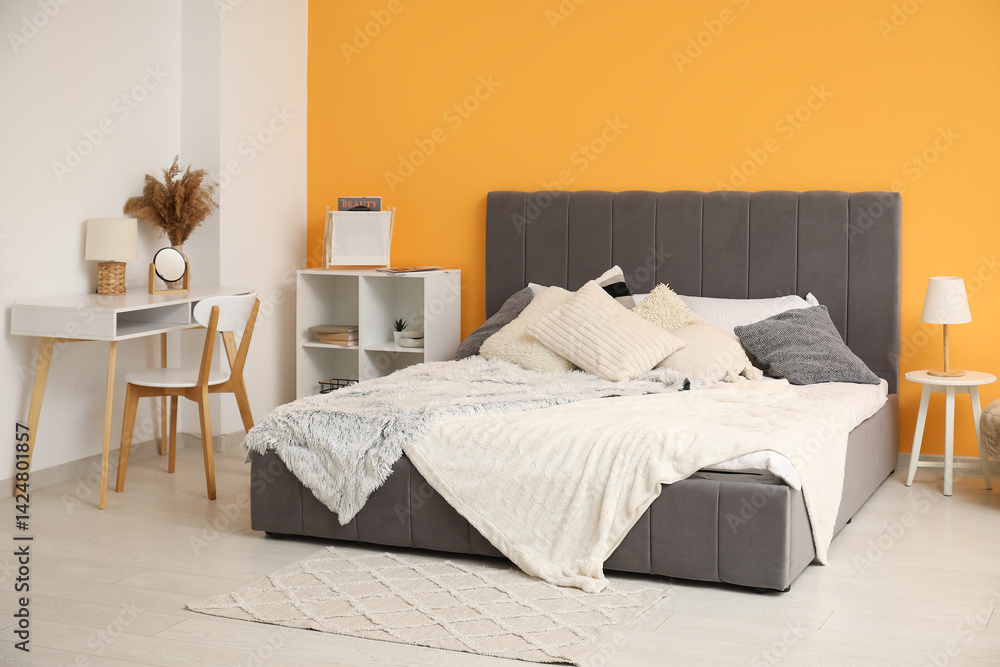 Modern bedroom with bed, bedside table and workplace