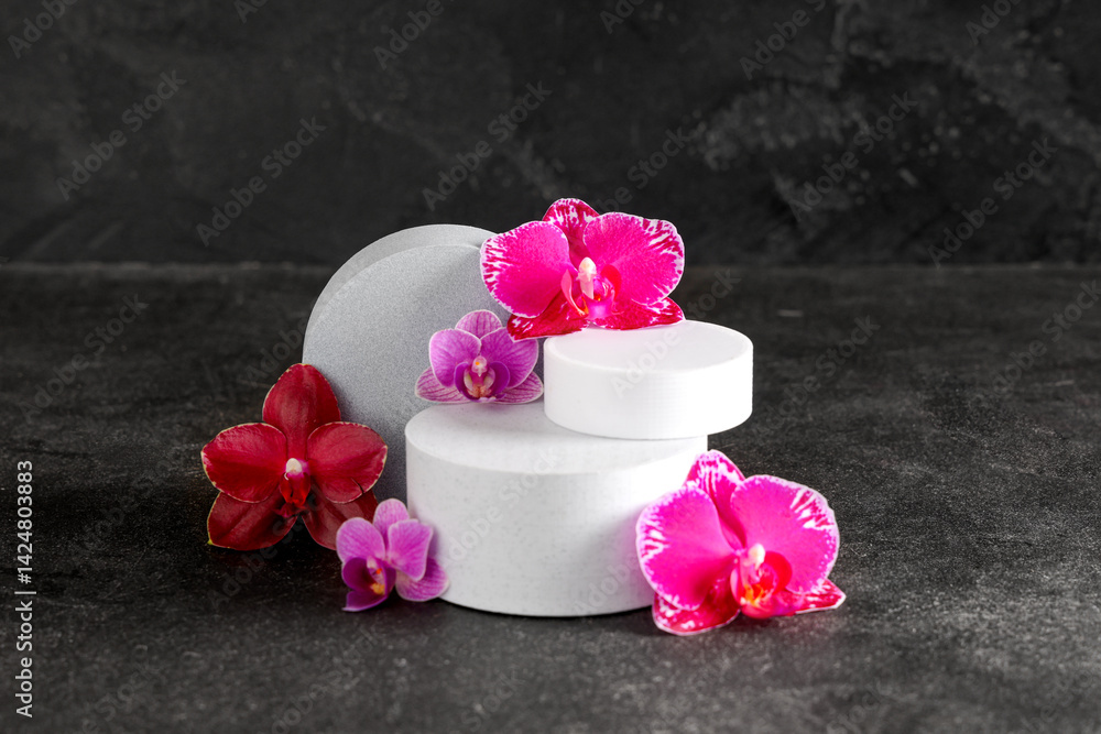 Decorative podiums with beautiful orchid flowers on black background