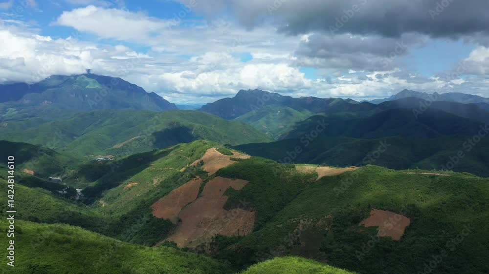 Mountains marked by deforestation in rural areas of Asia, in Laos, between Vientiane and Luang Prabang, in summer, on a sunny day. Mountains marked by deforestation in rural areas of Asia, in Laos, between Vientiane and Luang Prabang, in summer, on a sunny day.