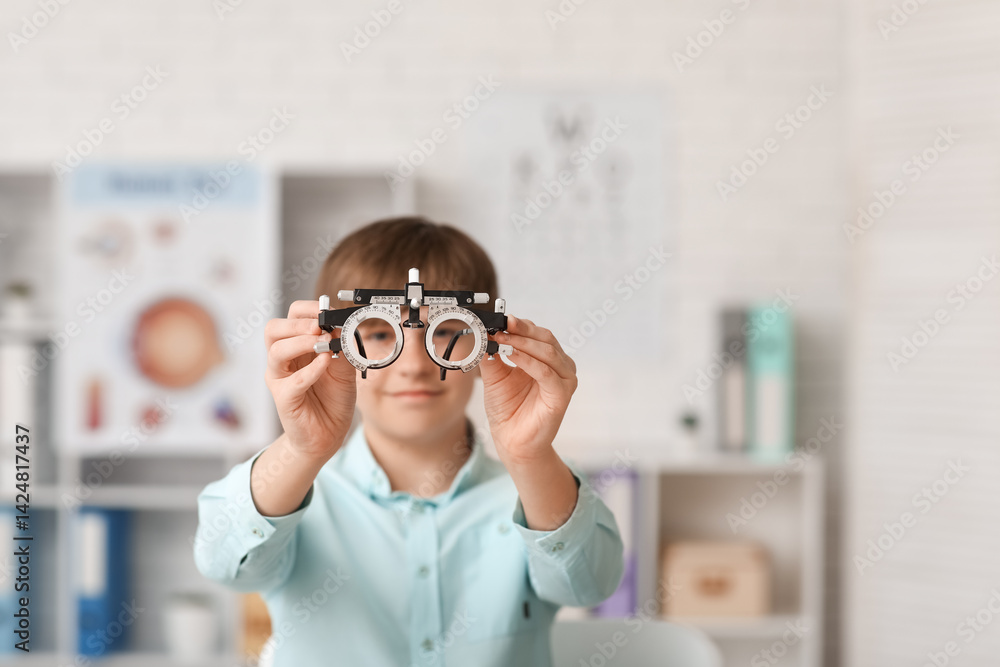 Little boy examining eyesight in light clinic