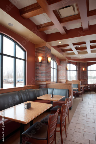 Wallpaper Mural Comfortable restaurant interior with wooden furniture, tables and chairs, brick walls, warm light from wall lamps, large windows revealing winter landscape, coffered ceiling design Torontodigital.ca