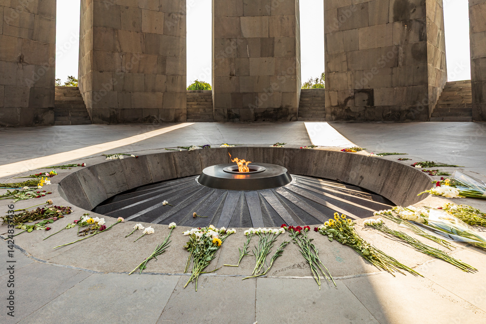 Yerevan, Yerevan Province, Armenia. The eternal flame with flowers, in the Memorial Hall at the Tsitsernakaberd Armenian Genocide Memorial Complex.