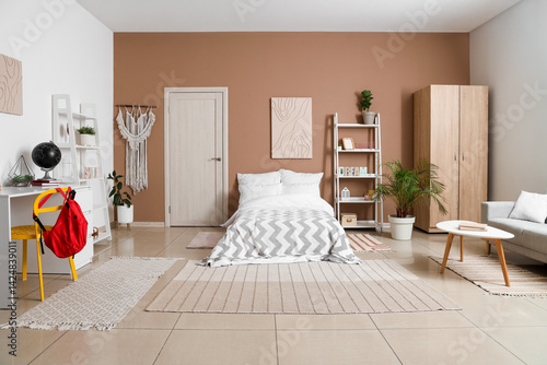 Obraz na płótnie Interior of teenager's room with bed, shelf units and study table w salonie